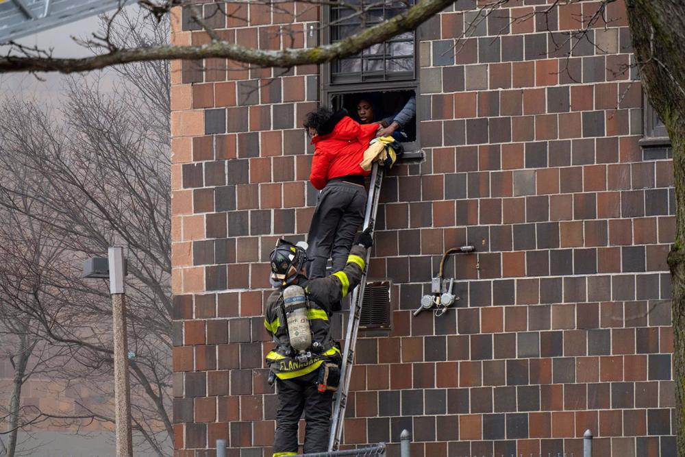 File - Firefighters evacuate residents of a building affected by a fire in the Bronx borough of New York. File. File