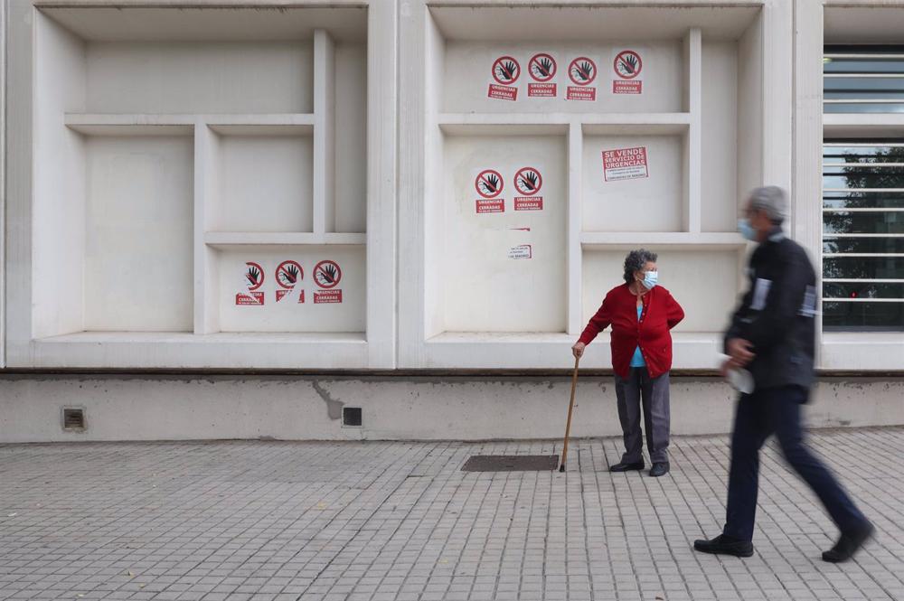 Dos personas mayores con mascarilla delante del Centro de Salud Pavones Dos