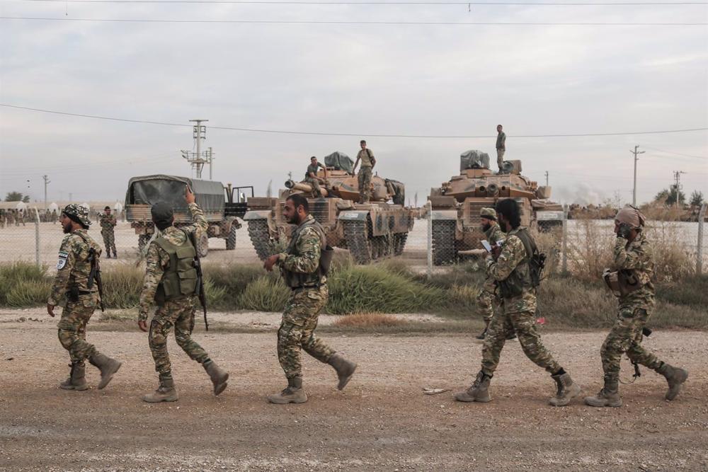File - Turkish soldiers and military vehicles at a staging area for the Army and Syrian rebels supported by Ankara. File