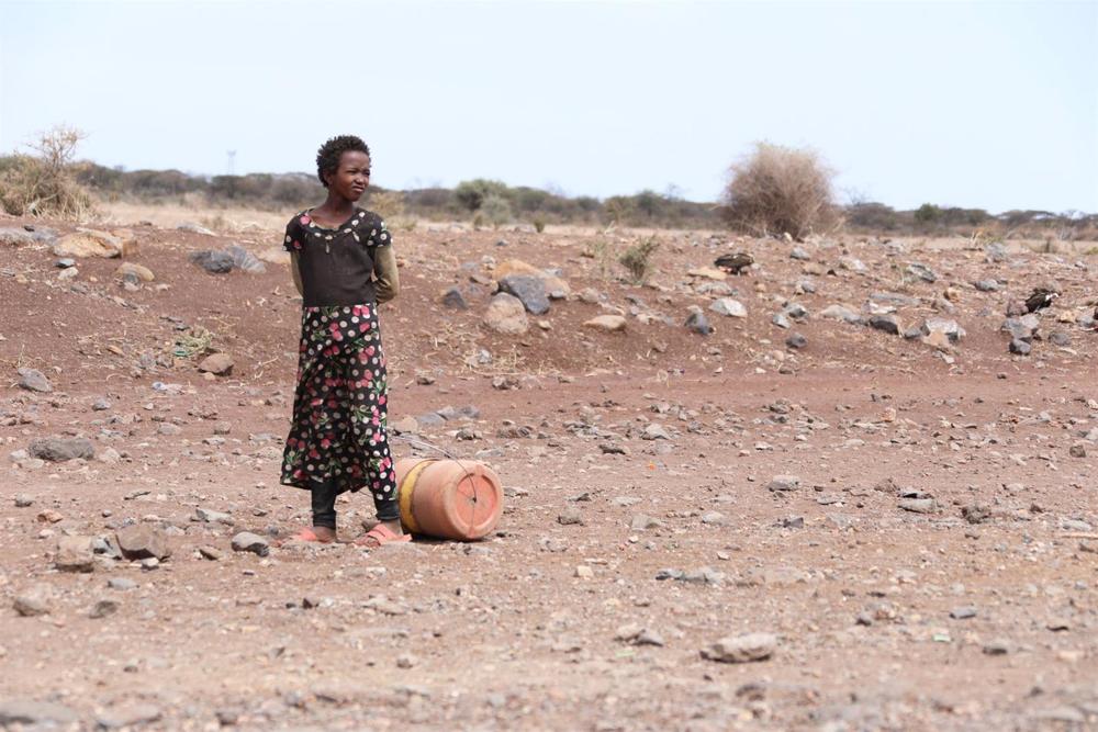 File - A young girl stands next to a jerrycan of water in Laisamis, Kenya, one of the areas affected by the drought. File