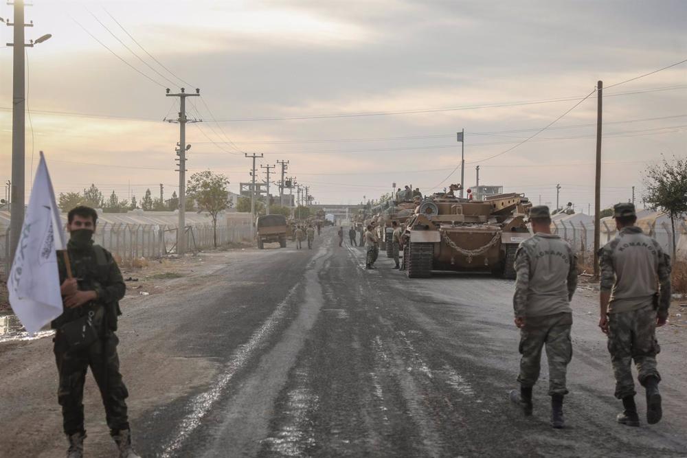 File - Turkish soldiers and military vehicles at a parking area for the army and rebels supported by Ankara in Syria near the border with the Arab country. File