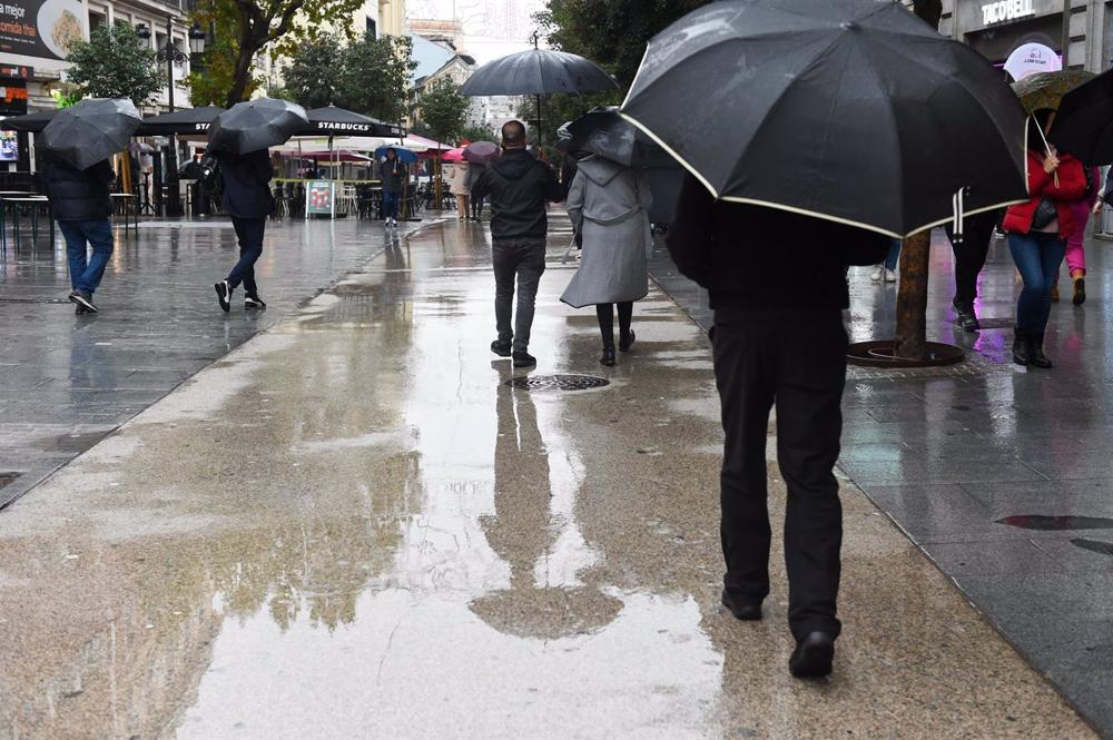 Personas caminan por la calle con paraguas, a 13 de diciembre de 2022, en Madrid (España). La previsión de la Agencia Estatal de Meteorología (Aemet) en la Comunidad de Madrid para hoy apunta a que las lluvias persistirán y que las temperaturas aumentarán Personas