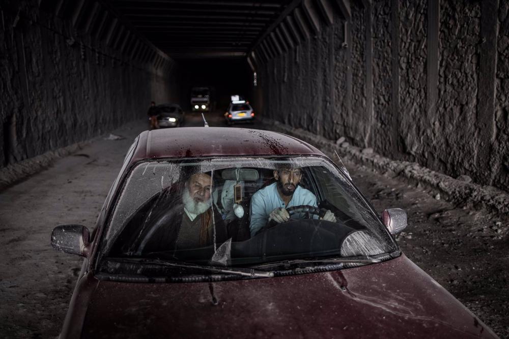 File - Two Afghans drive through the Salang Pass in northern Afghanistan. File