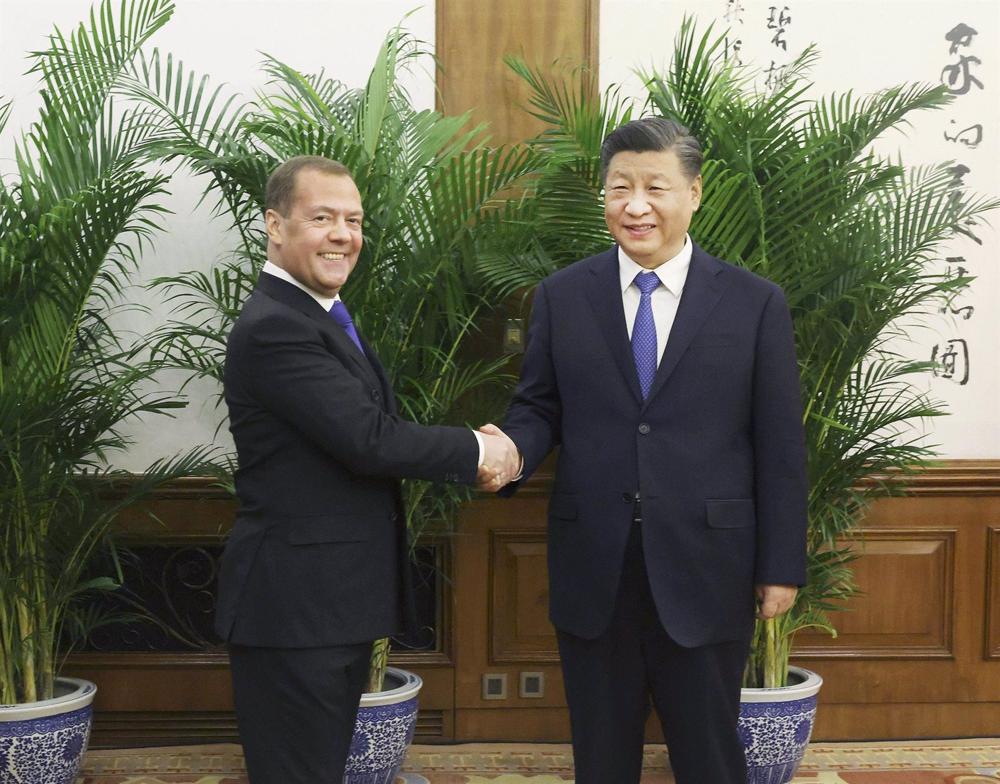 Former Russian President Dmitry Medvedev and Chinese President Xi Jinping. Former