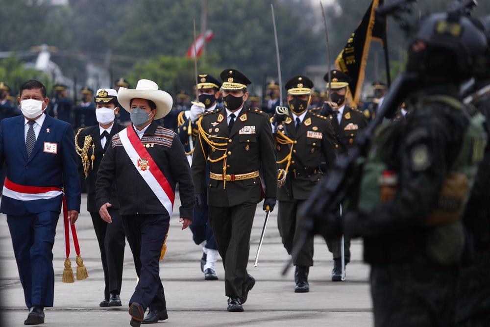 File - Former Peruvian Minister of Defense Walter Ayala (L), next to former Peruvian President Pedro Castillo (C) during a military act File
