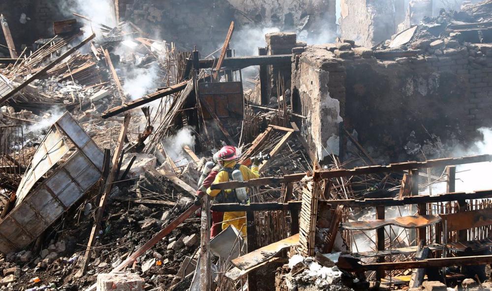 File - A Peruvian firefighter after a house fire in Lima, Peru. File