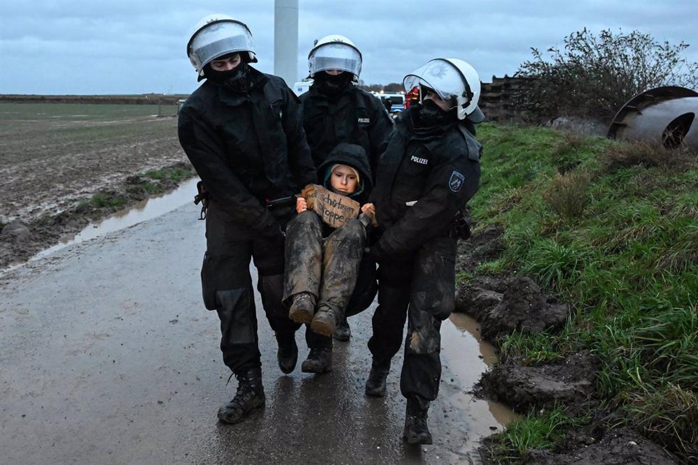 German police evacuate an environmental activist during a sit-in in the mining town of Luetzerath. German
