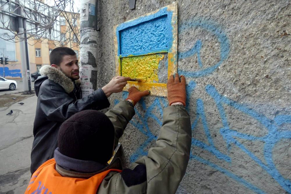 Archive - City officials painting a Ukrainian flag in Odessa. Archive