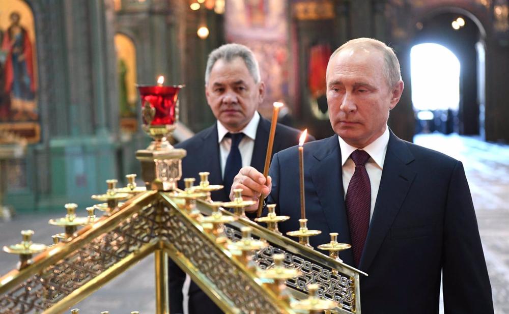 File - Russian President Vladimir Putin prays in an Orthodox church. File