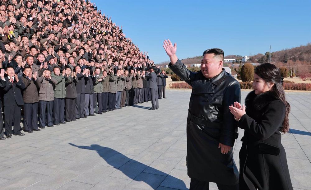 File - North Korean leader Kim Jong Un greets a group of military personnel with his daughter. File