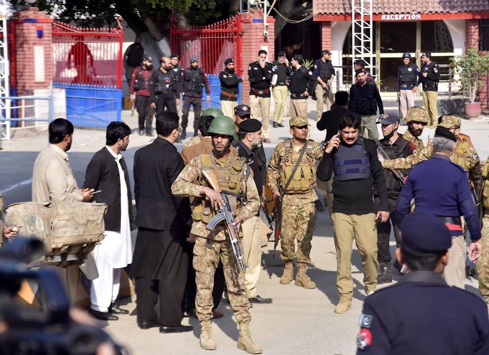 Security personnel stand guard at the site of the blast in Peshawar, northwest Pakistan. Security