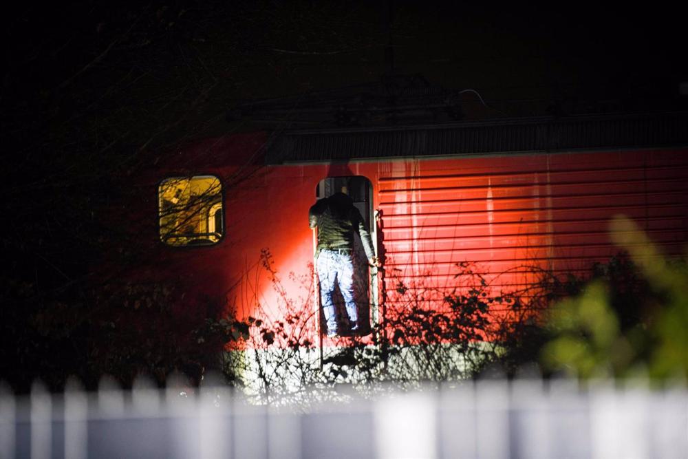 A man stands next to a train carriage at the site where two children were hit by a freight train in Recklinghausen. A