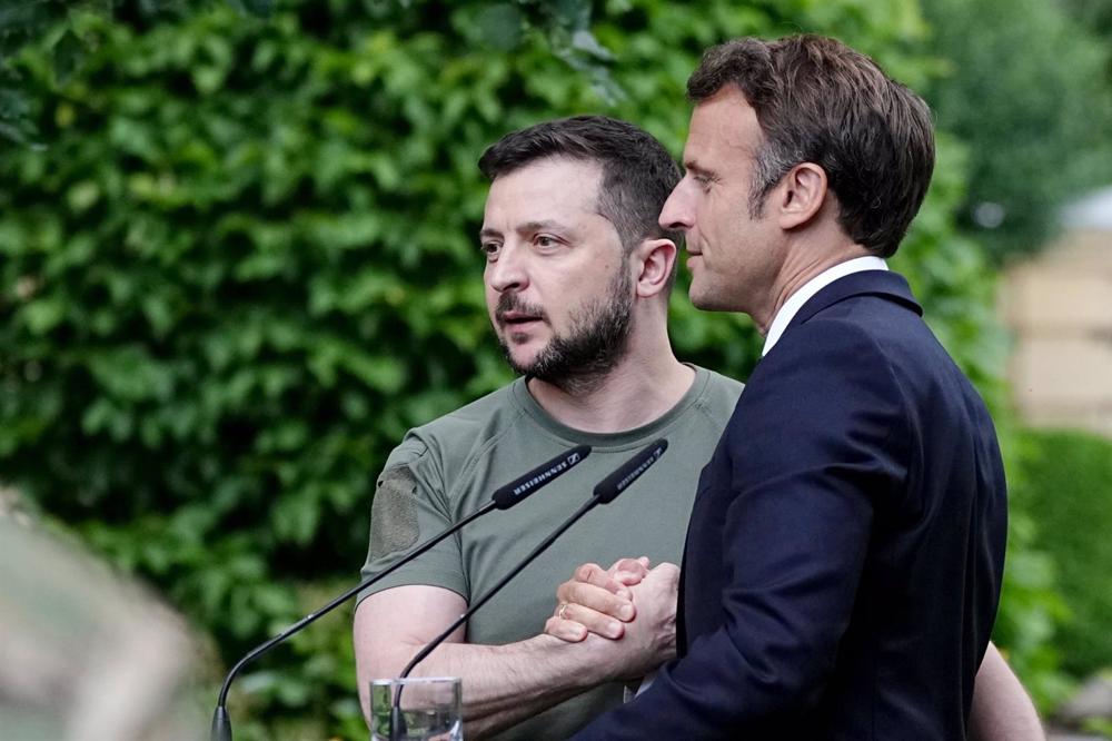 File - File image of Ukrainian President Volodimir Zelenski (L) with his French counterpart Emmanuel Macron during a visit of the French President to Kiev. File