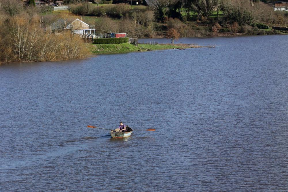 Archivo - Un batuxo, embarcación tradicional del río Miño, surca las aguas del río Miño tras la crecida, a 2 de enero de 2023, en Portomarín, Lugo, Galicia (España). Las intensas lluvias caídas en la jornada de fin de año y el primer día del año 2023 han Archivo