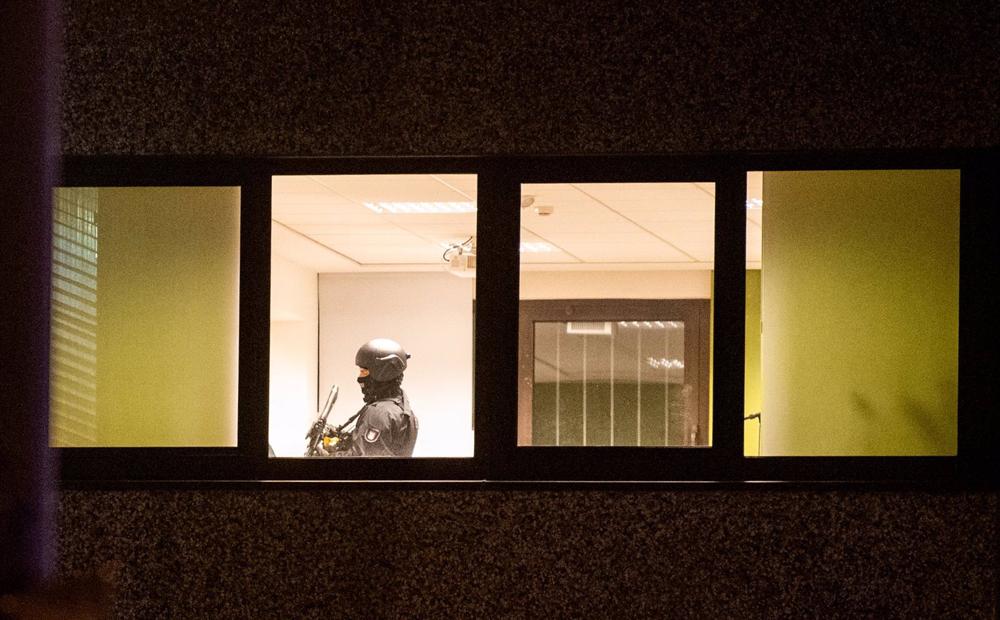 A policeman inside the religious center of the Jehovah's Witnesses of Hamburg after the shooting. A