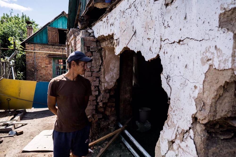 File - Ukrainian citizen in front of a destroyed house in Nikopol, Dnipropetrovsk region. File