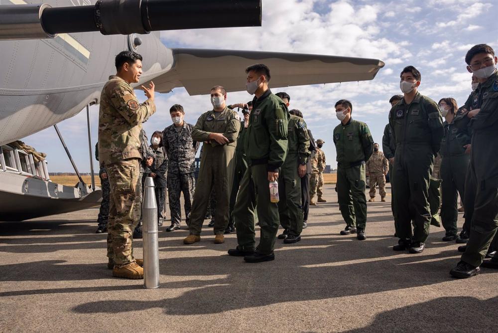 File - U.S. Air Force Capt. Nestor Soriano describes the unique capabilities of the AC-130J Ghostrider combat helicopter to members of the Japan Self-Defense Force. File