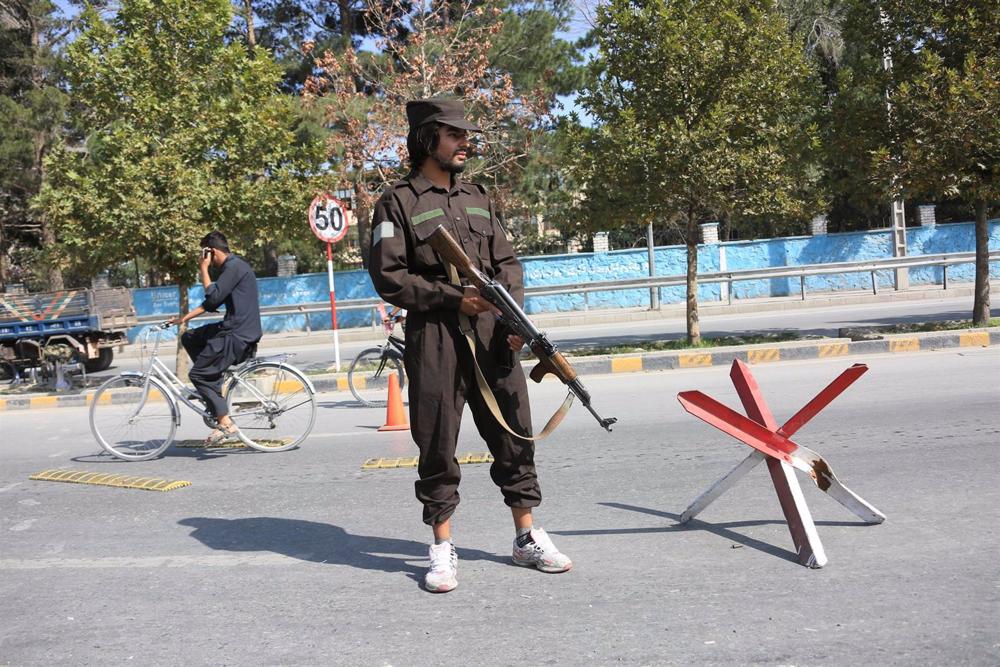 File - A member of the Afghan security forces stationed near the scene of an explosion in Kabul. File