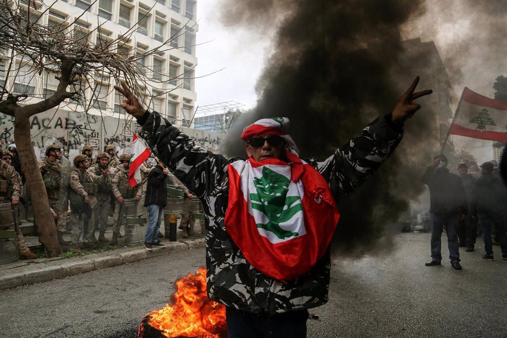 Un militar retirado con una bandera de Líbano Un