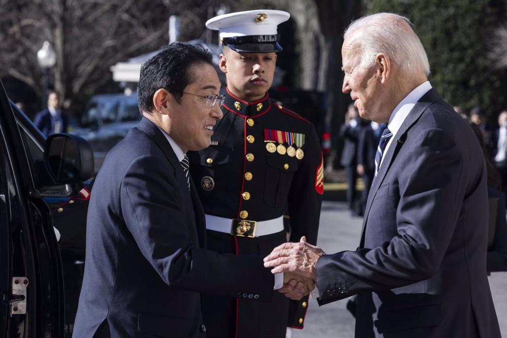 File - U.S. President Joe Biden (right) shakes hands with Japan's Prime Minister Fumio Kishida (left). File