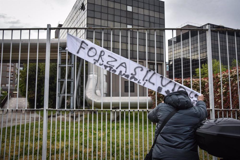 A supporter of former Italian Prime Minister Silvio Berlusconi places a banner reading 'Fuerza Silvio' in front of the hospital where he is admitted in Milan. A