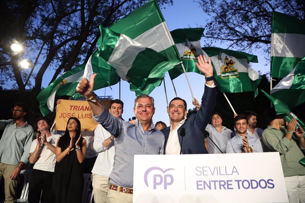 El presidente del PP-A y de la Junta de Andalucía, Juanma Moreno (d), junto a candidato del PP a la Alcaldía, José Luis Sanz (i), durante el acto de cierre de campaña en la Plaza de San Gonzalo de Triana. El